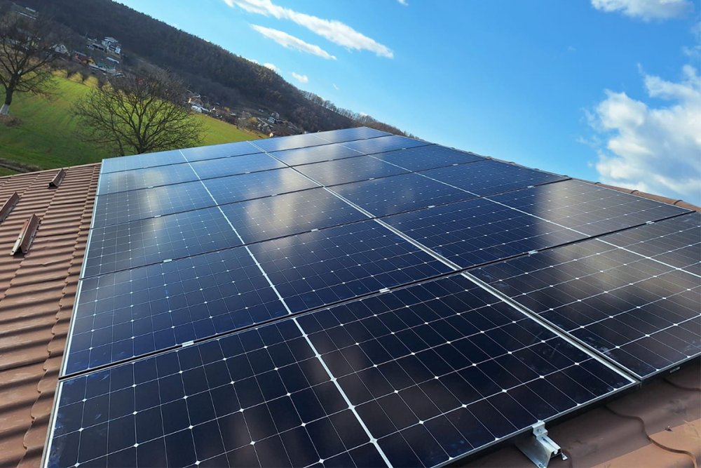 Panouri solare montate pe acoperișul unei case, exemplu de sistem fotovoltaic ales în funcție de consumul locuinței și de buget.